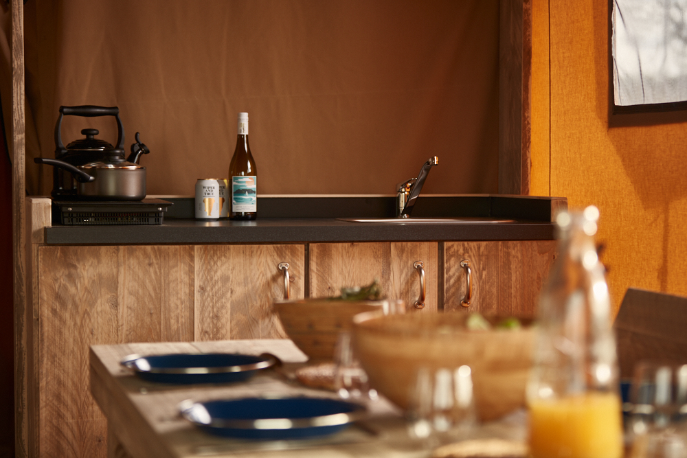 
								The kitchen area of a glamping safari tent in The Camp at The Wave great campsite for UK holidays							